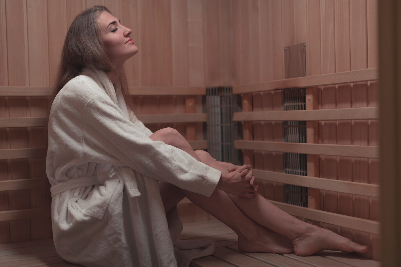 Woman relaxes after exercising inside her infrared sauna